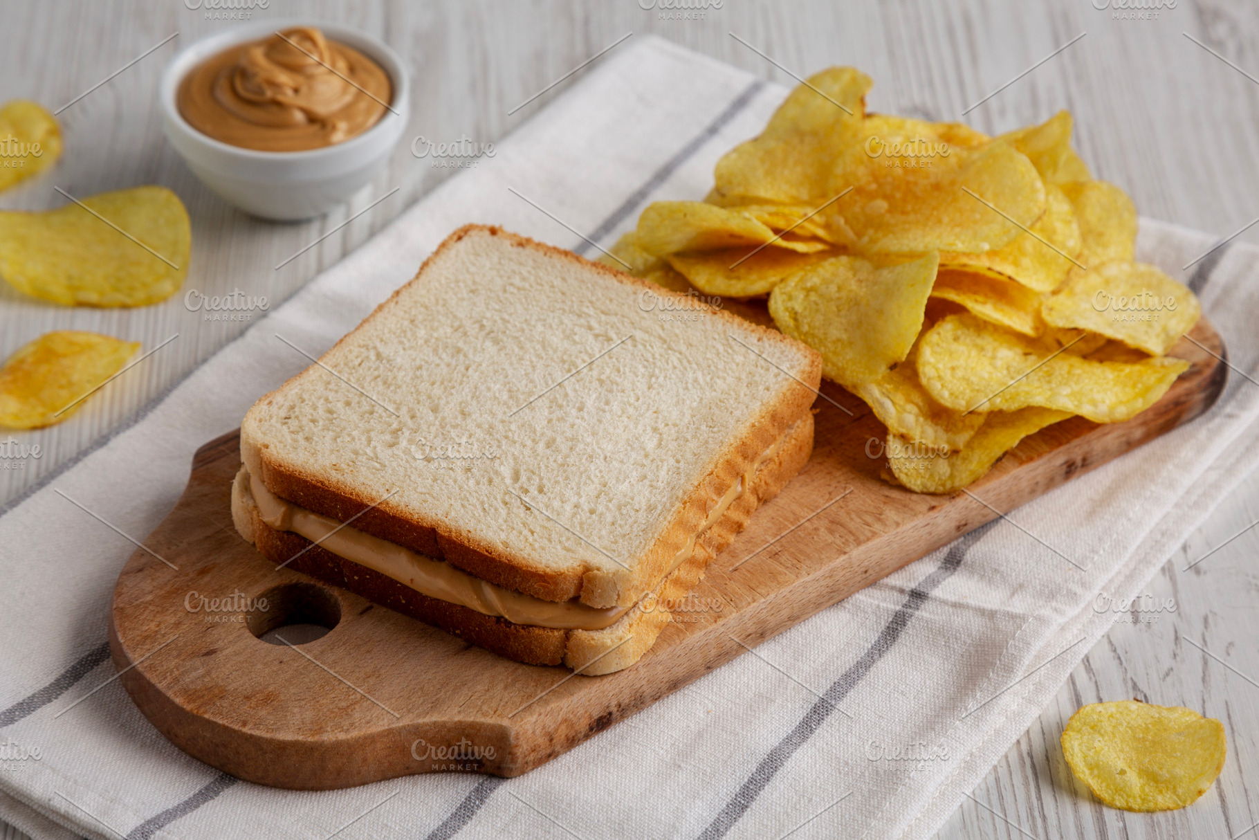 Homemade American Peanut Butter Sandwich and Potato Chips, side, a Food & Drink Photo by LiudmylaChuhunova