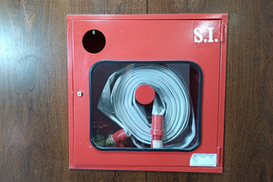 Red fire hose cabinet on wall, an Industrial Photo by DanFLCreativo