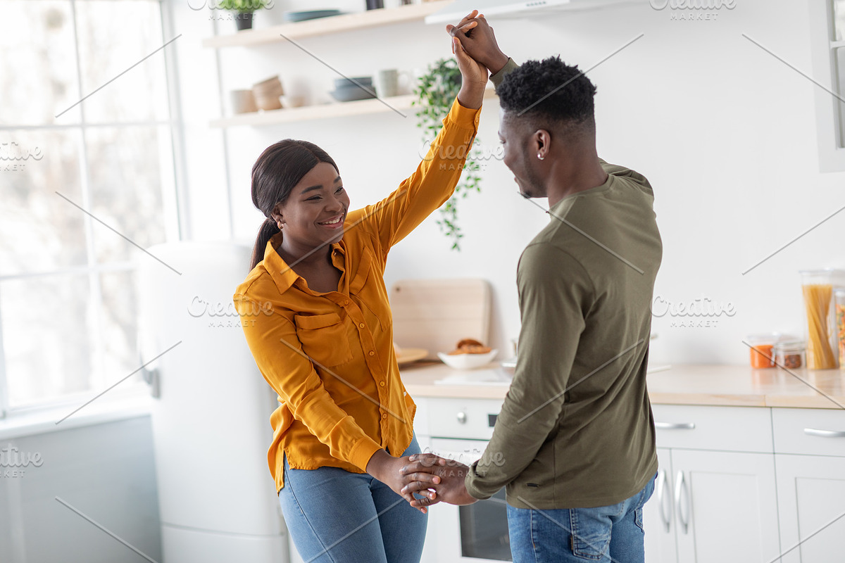 Portrait Of Joyful Black Millennial Couple Having Fun In Kitchen Interior, a Photo by Prostock-Studio (Photo 1 of 2)
