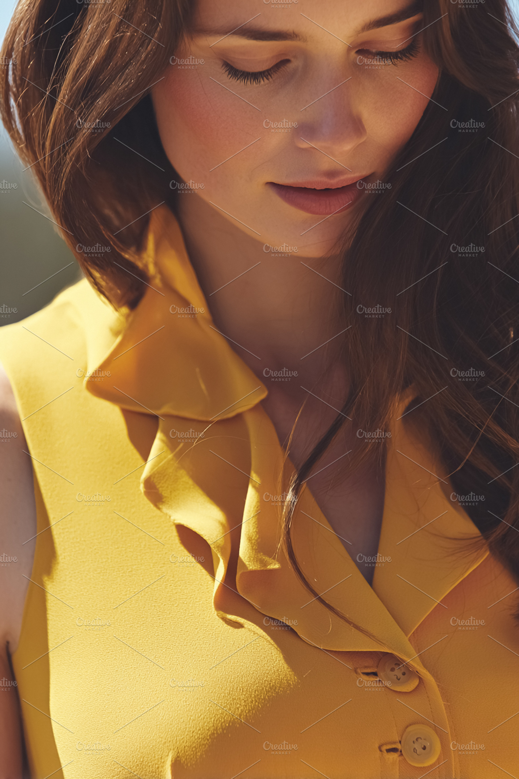 Elegant young woman closing eyes, wearing a stylish ruffled yell, a Photo by Studio ANNA