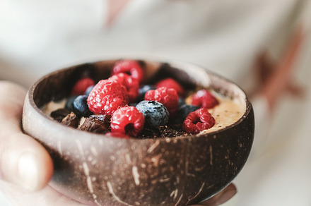Woman holding healthy breakfast bowl, a Food & Drink Photo by Foxys