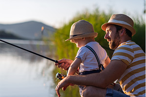 Dad teaching his little boy how to, a Person Photo by HalfPoint