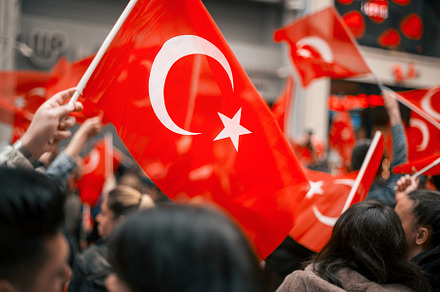 People waving turkish flag at the Co