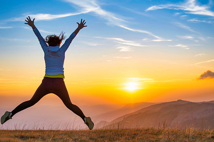 Young woman jumping at sunset mountains, a Person Photo by Vapi