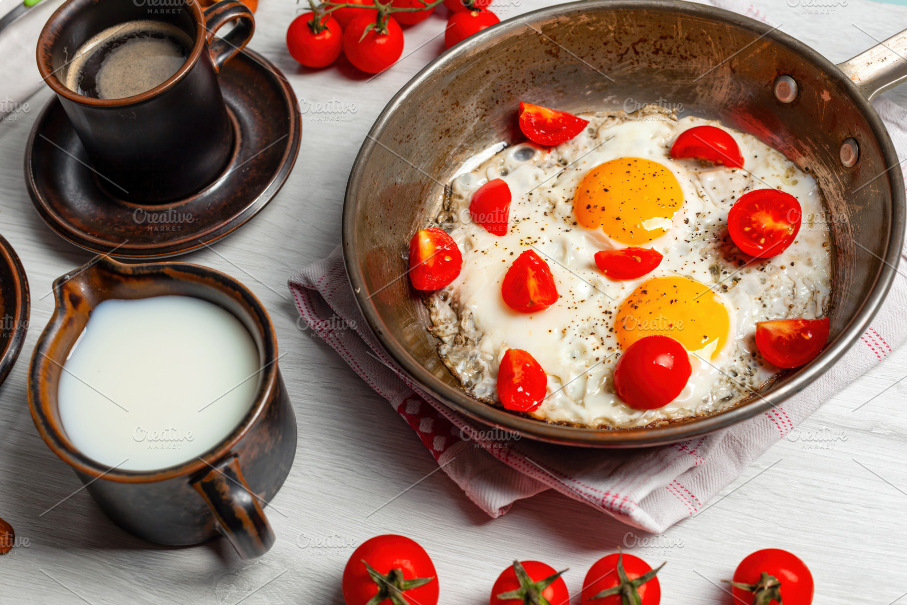 Delicious breakfast with fried eggs and cherry tomatoes in a pan, coffee and mi, a Food & Drink Photo by Antonio Gravante Market