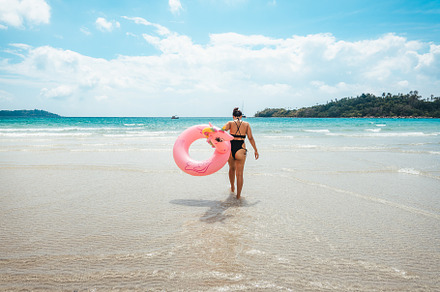 Summer travel, woman holding an inner tube, walking in the middl, a Nature Photo by Art Rachen