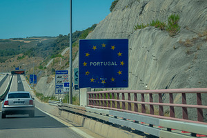 Cars entering portugal on highway bridge, a Transportation Photo by DanFLCreativo