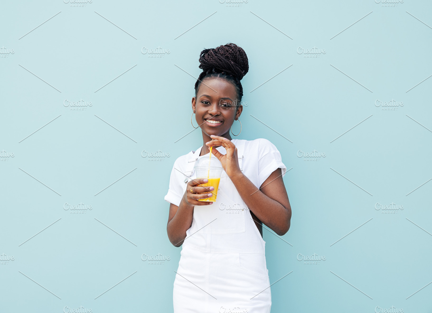 Smiling woman against blue wall, a Person Photo by Artem Varnitsin