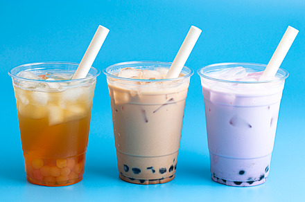 Three Different Types of Boba Tea on a Bright Blue Background