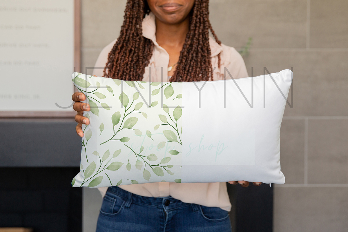 Black Model Holding Pillow Mockup #4, a Product Mockup by JENLYNN Stock Shop (Photo 1 of 4)