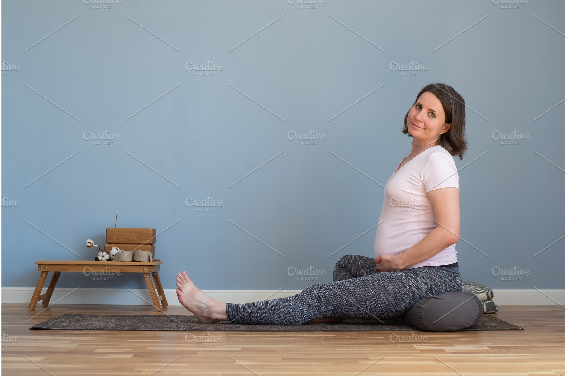 Pregnant woman sitting on yoga mat, a Sports & Recreation Photo by Koldunov