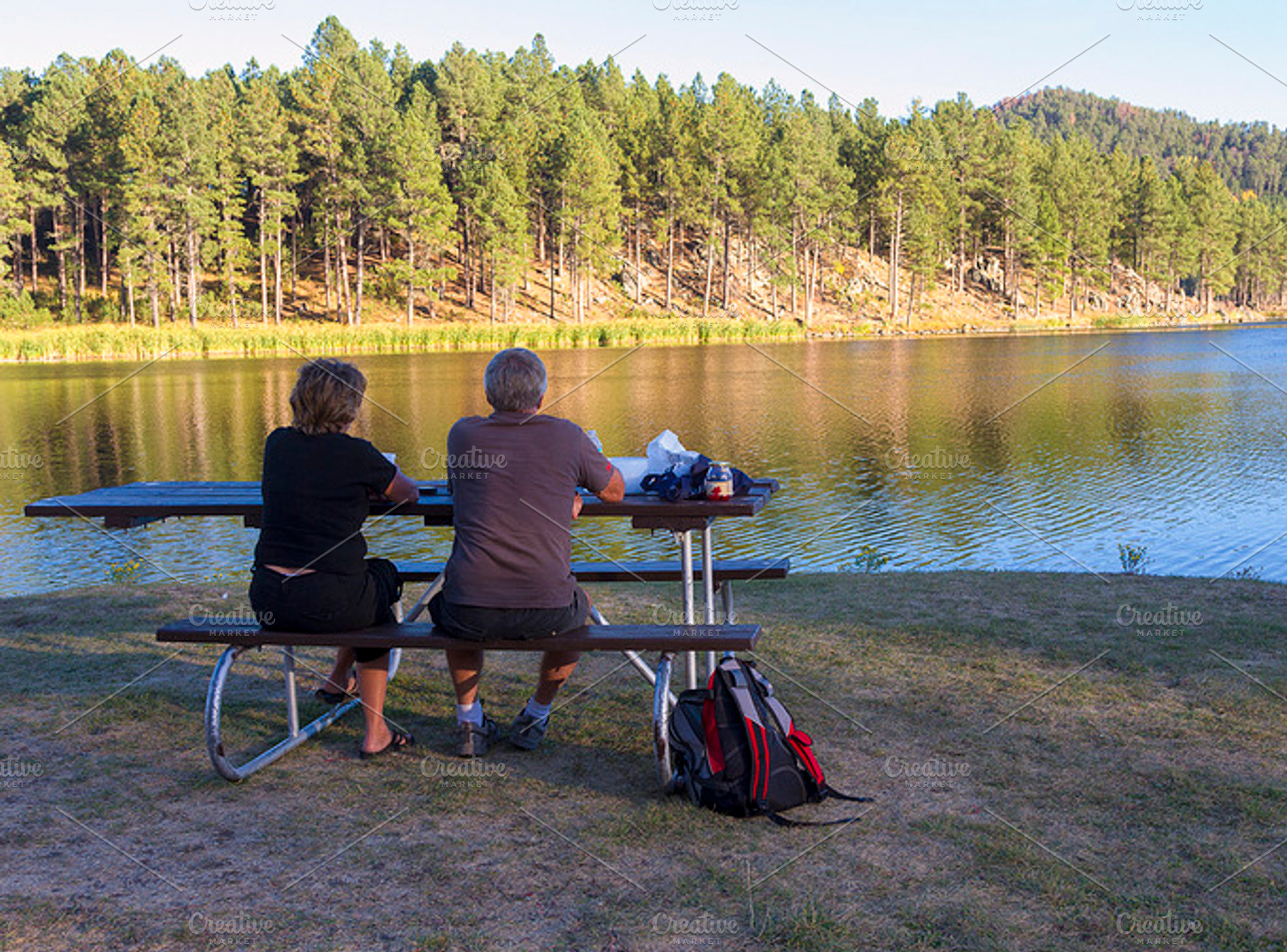 Couple relaxing at lake stock photo containing beautiful and calm, a Person Photo by RodeoPixels WesternImage
