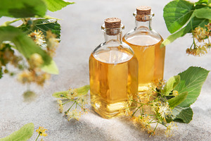 Linden flower essential oil in glass bottles, a Health & Medical Photo by Olena Rudo