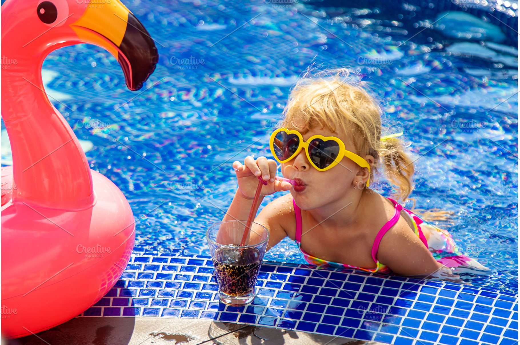 A child near the pool in sunglasses, a Person Photo by yanadjana