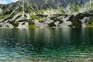 Tranquil mountain lake in Zakopane Poland with clear water and rocky alpine sho, a Nature Photo by AS photostudio