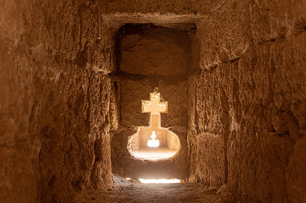 Divine cross in stone cave of ancient building, a Holiday Photo by Iván Moreno STOCK PHOTO