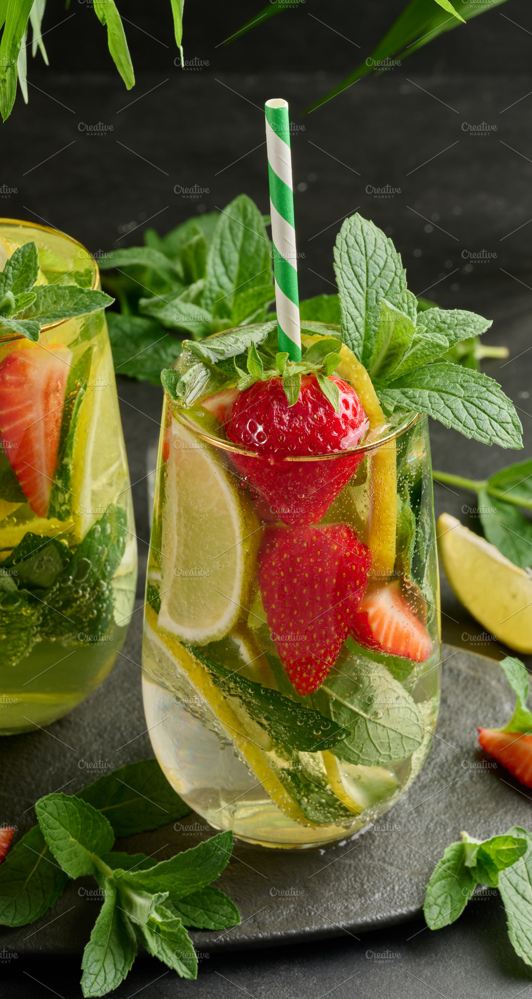A refreshing drink in a glass with lemon slices, strawberries, f, a Food & Drink Photo by ndanko
