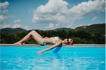Young woman lying by the on edge of