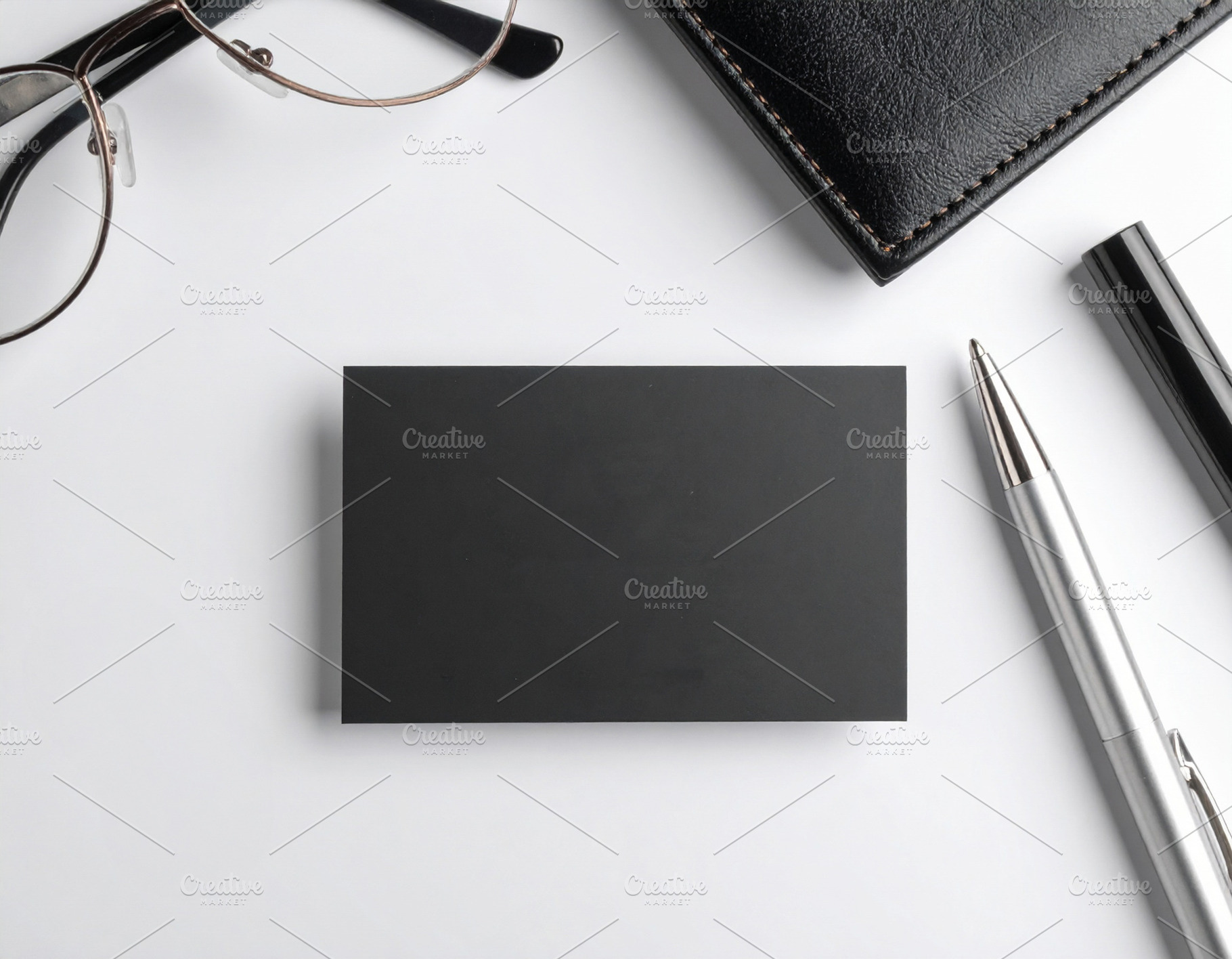 Modern black business card centered on a white desk, a Business Photo by DanFLCreativo