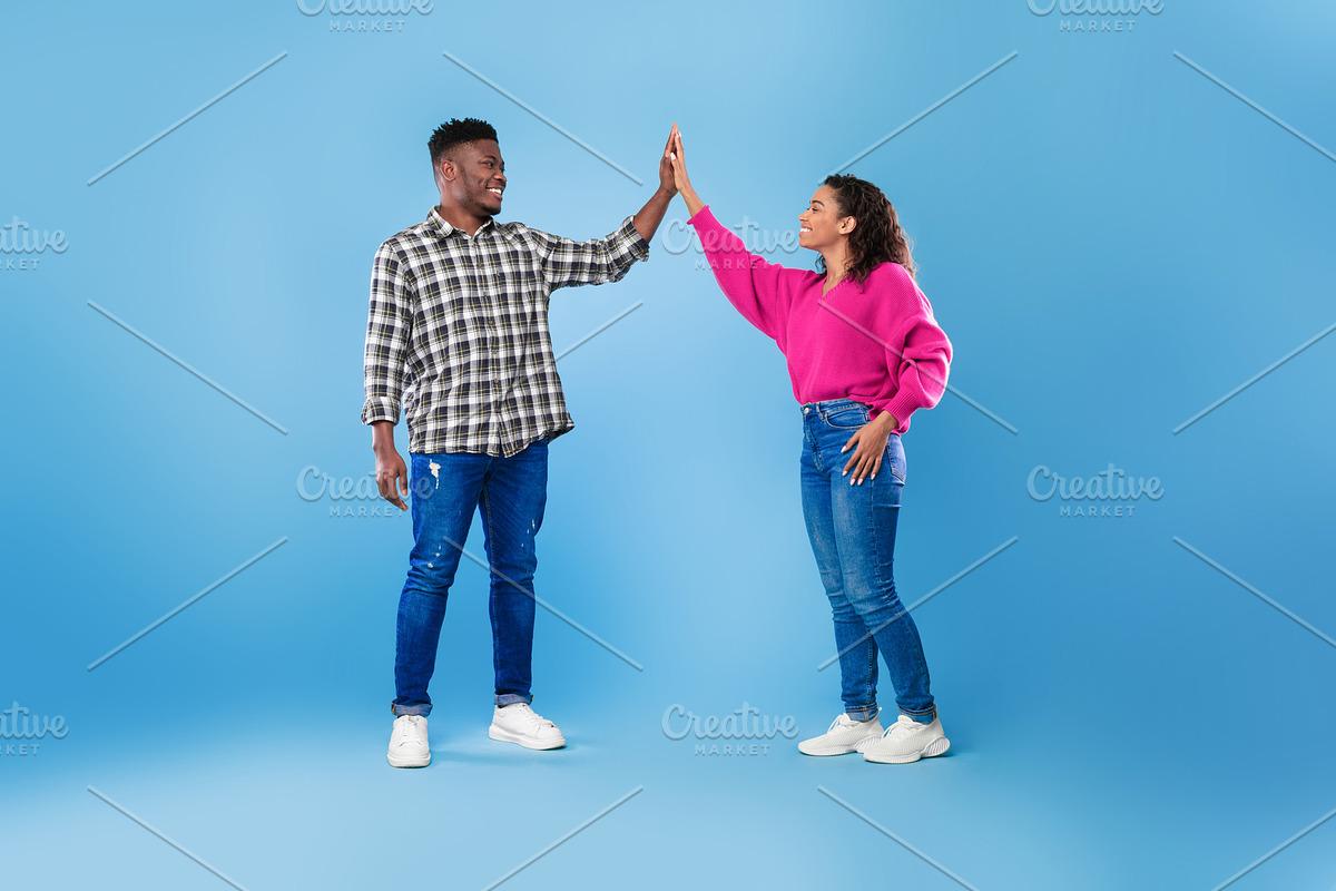 Joyful young African American couple giving high five to each other, celebratin, a Photo by Prostock-Studio (Photo 2 of 2)