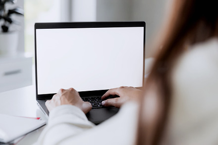 Woman hands typing on the laptop with blank white screen mockup laying on table, a Technology Photo by Lenor4ik