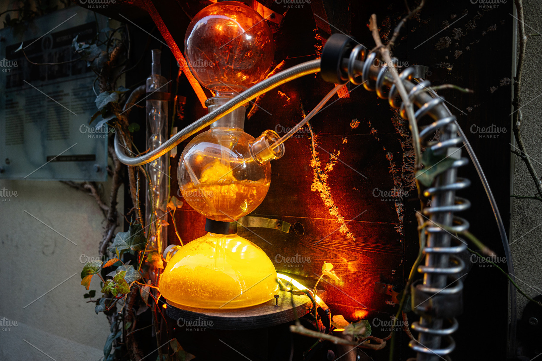 Vintage alchemy laboratory apparatus illuminated with vibrant orange glowing li, a Photo by AS photostudio