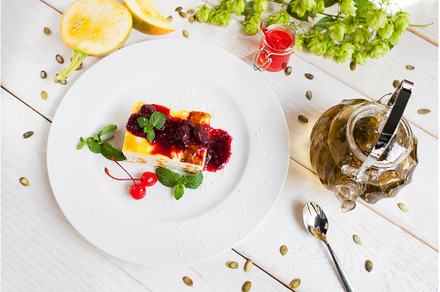 Cheesecake with red topping and tea, a Food & Drink Photo by Photo Drive Studio