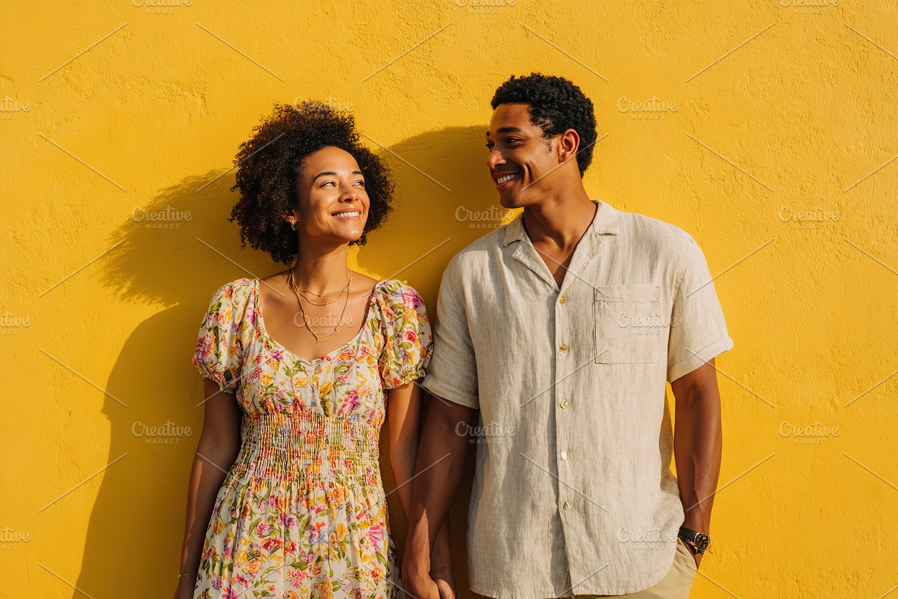 Couple enjoying a warm moment together against a vibrant yellow wall in a sunny, a Photo by AlyaAnd