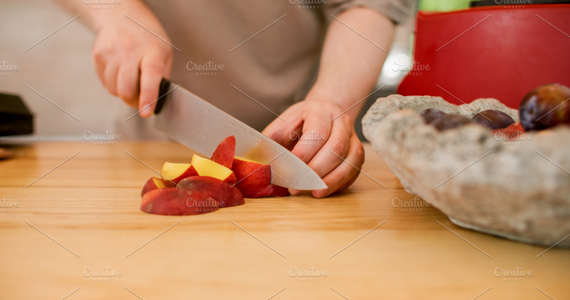 Hand cutting peach fruit preparation knife plums, a Food & Drink Photo by Photo Drive Studio