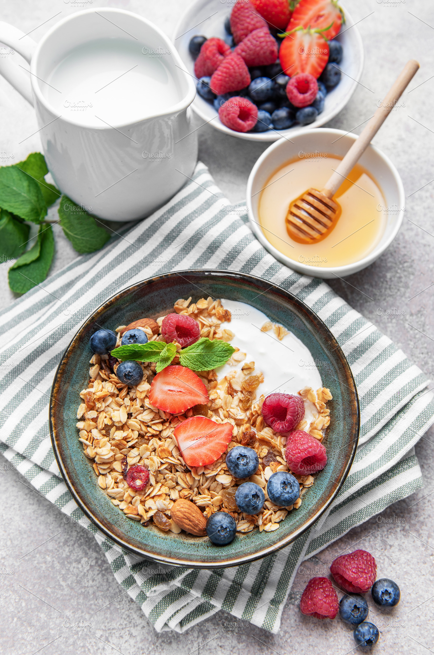 Granola bowl with yogurt, berries, and mint for breakfast, a Food & Drink Photo by Olena Rudo