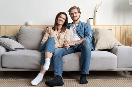 Caucasian couple relax on cozy sofa, a Person Photo by OPOLJA