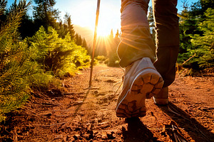 Legs of a mountaineer walking along path with evening sun, a Sports & Recreation Photo by Davizro's Market