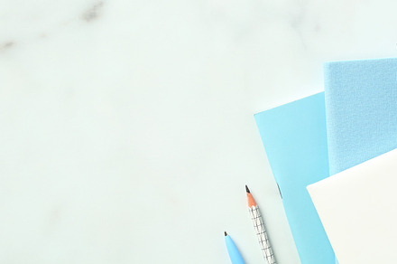 Marble office desk table with paper notebooks, eye glasses, pen, pencil. Flat l, a Business Photo by photoguns