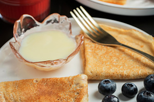 Pancakes with blueberry and honey on a white plate, a Food & Drink Photo by Budarinphoto
