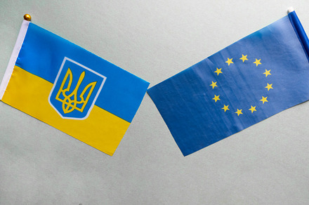 European union and Ukraine two folded silk flags together