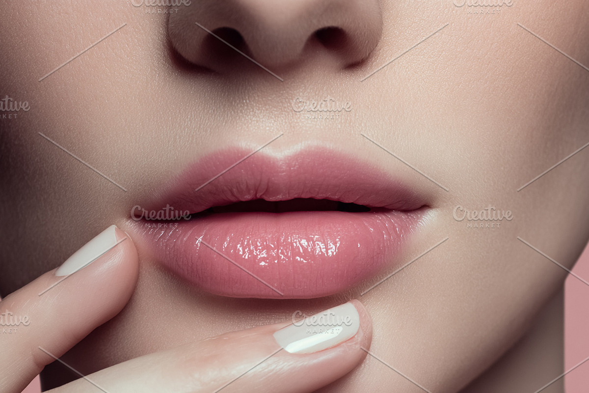 Applying pink lip gloss for glossy lips on beautiful female face, a Beauty & Fashion Photo by Studio ANNA (Photo 1 of 2)