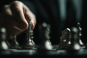 Hand in a suit carefully moves chess, a Business Photo by MistyDay