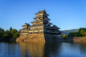 Matsumoto Castle reflecting in the water at sunset, Japan, an Architecture Photo by GoodGoods