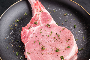 Juicy raw pork chop with bone in, waiting to be transformed into, a Food & Drink Photo by composter-box@mail.ru