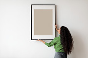 Happy Woman Hanging Empty Poster In Frame On Wall Indoors, a Photo by Prostock-Studio (Thumbnail 3 of 4)
