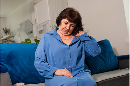 Older woman in blue shirt suffering, a Person Photo by oksix