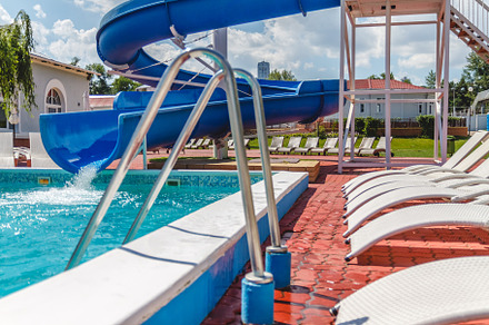 A number of many light loungers near the pool with a slide, a Sports & Recreation Photo by TanaCh