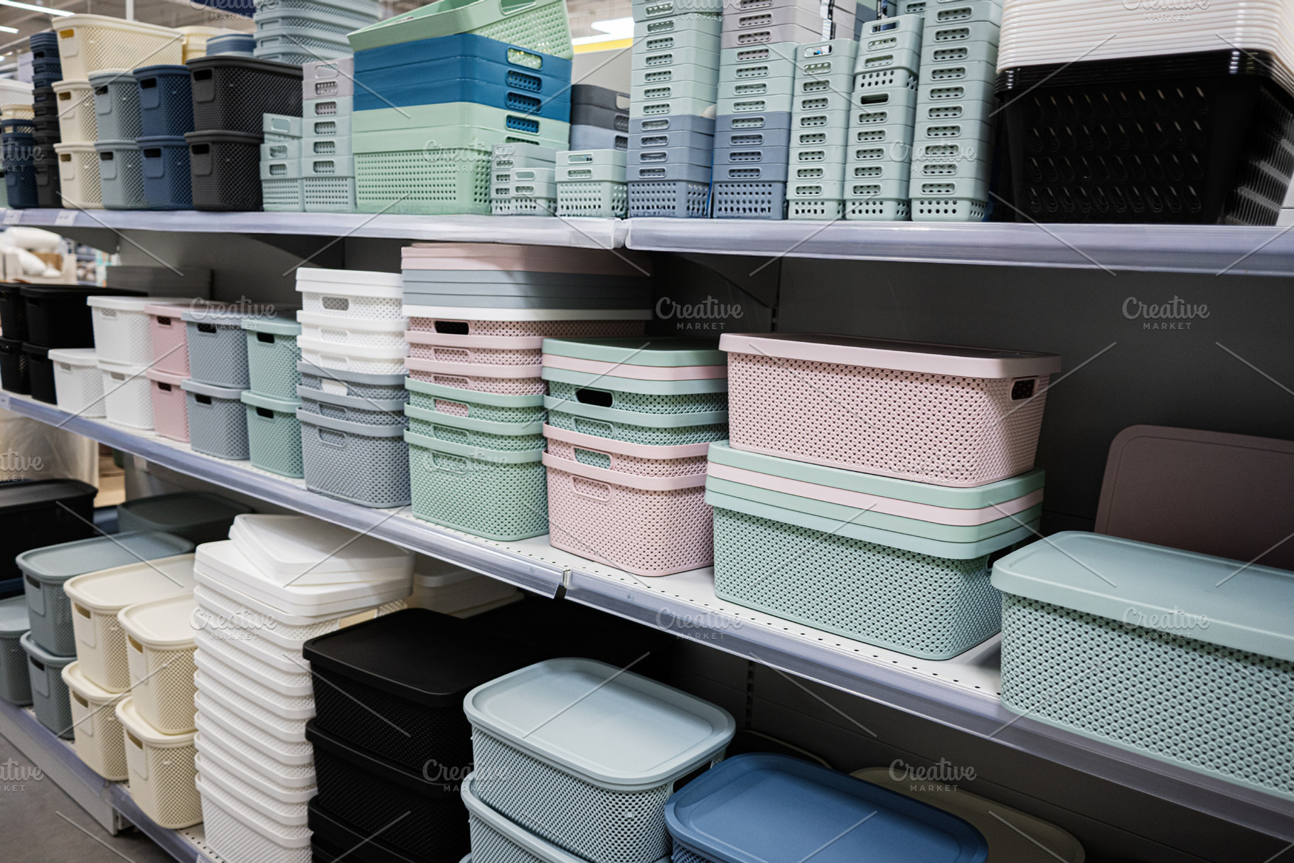 Assorted plastic storage boxes stacked neatly on store shelves, a Photo by AS photostudio