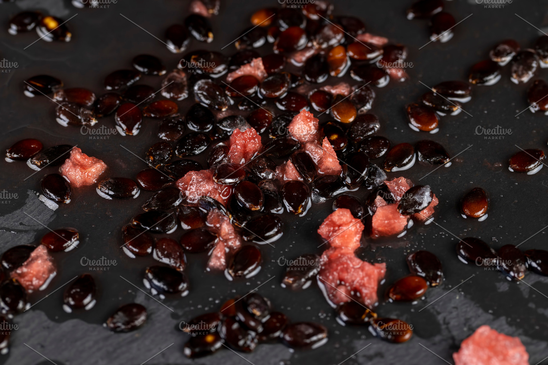 watermelon seeds on black slate, watermelon seeds after peeling the pulp on a b, a Photo by rsoollAI