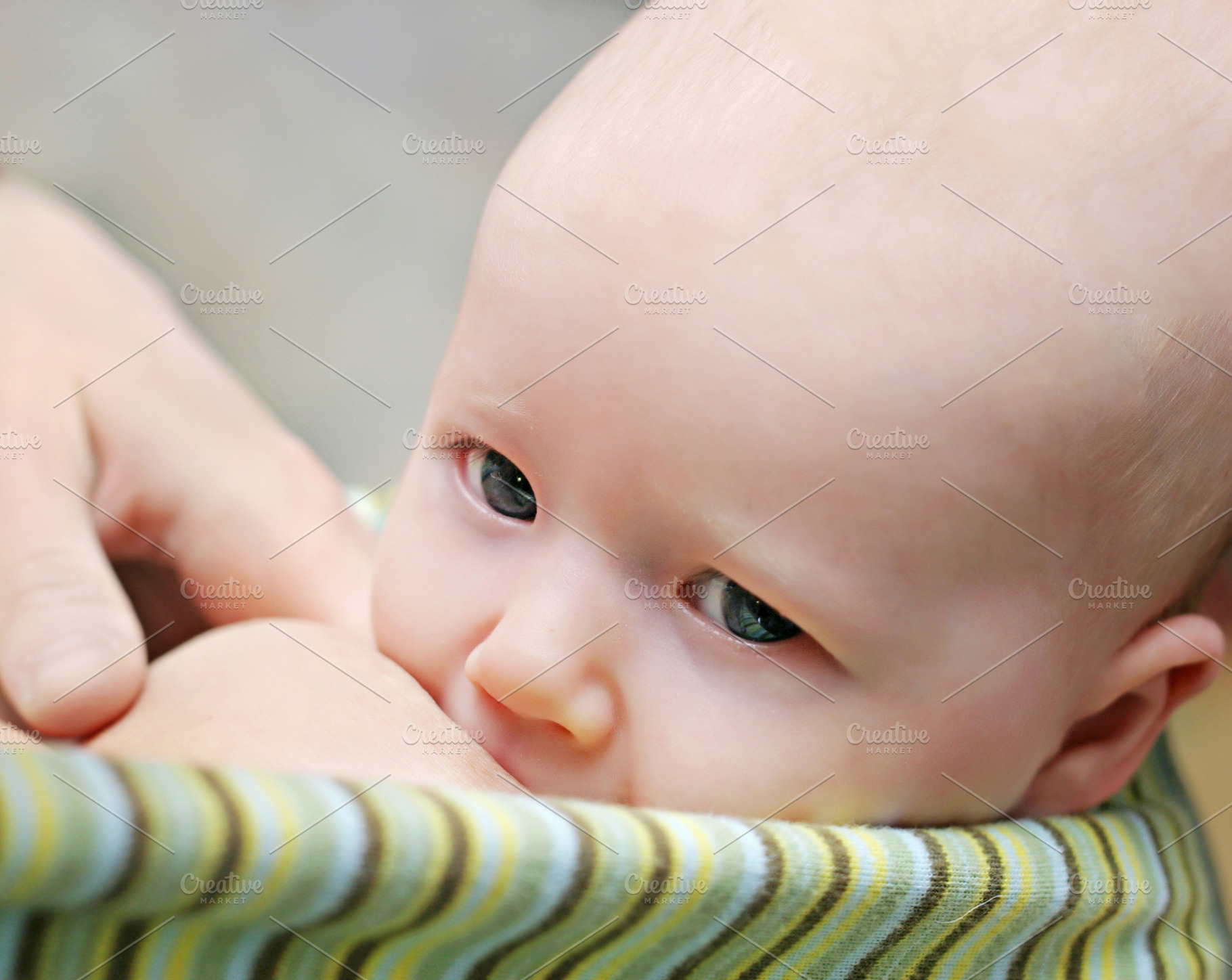 Mother breast feeding her newborn baby, a Photo by saiko3p