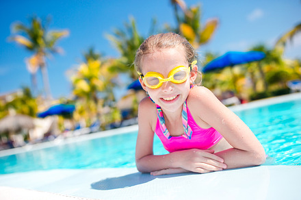 Portrait little girl having fun in outdoor swimming pool stock photo, a Person Photo by travnikovstudio