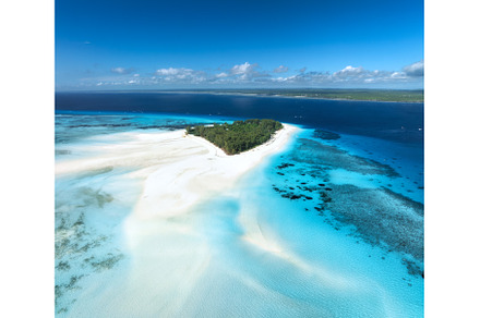 Aerial view of blue sea and Mnemba, a Nature Photo by den-belitsky