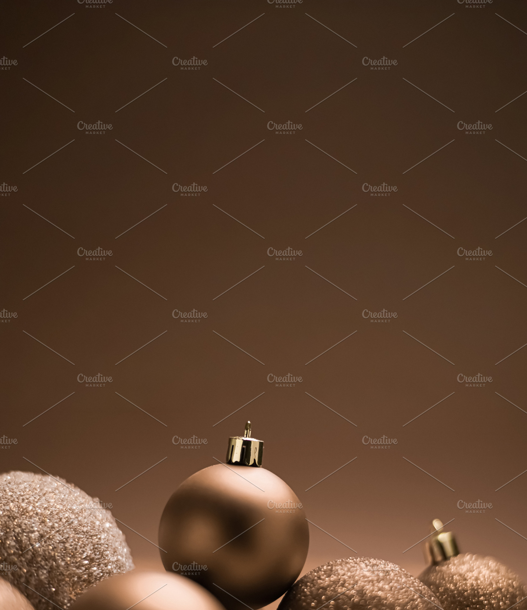 Brown Christmas ornaments creating a festive holiday backdrop with ample copy s, a Photo by Studio ANNA