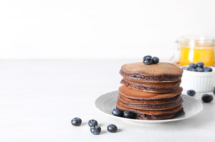 Concept of sweet food, chocolate pancakes, space for text, a Food & Drink Photo by AtlasStudio PRO