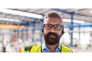 Production manager using headset, a Person Photo by HalfPoint